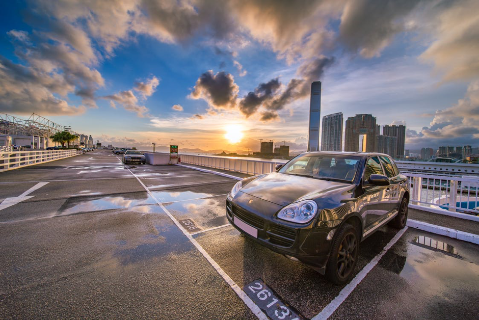 Car in outdoor car park with cityscape in the background