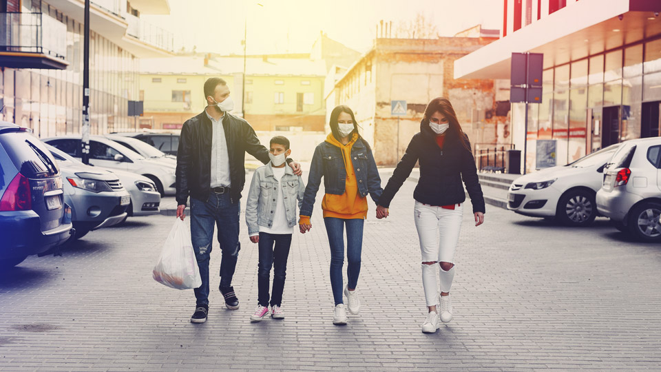 Young family walking back to car in car park